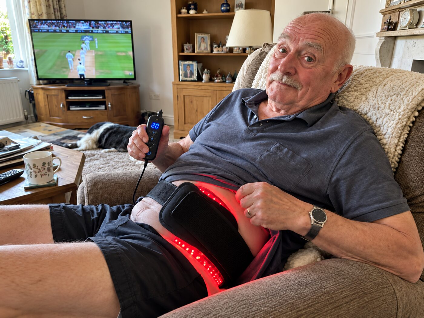 Man using LumaWrap on his hip on the sofa